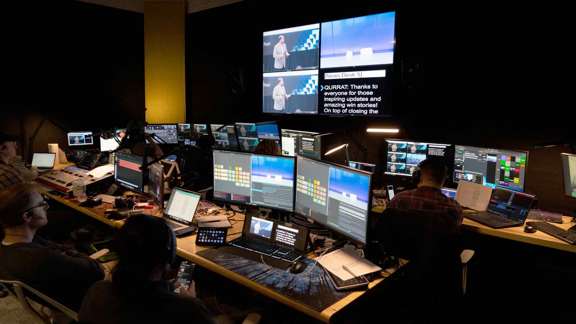 Picture of a control room in operation and full of people
