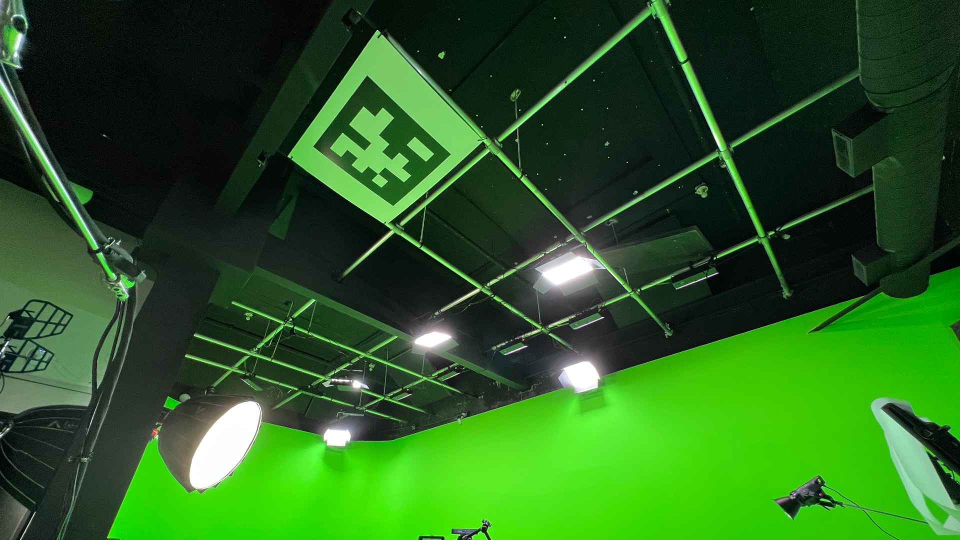 Picture of a large ArUco board that is zip-tied to the lighting grid above the stage